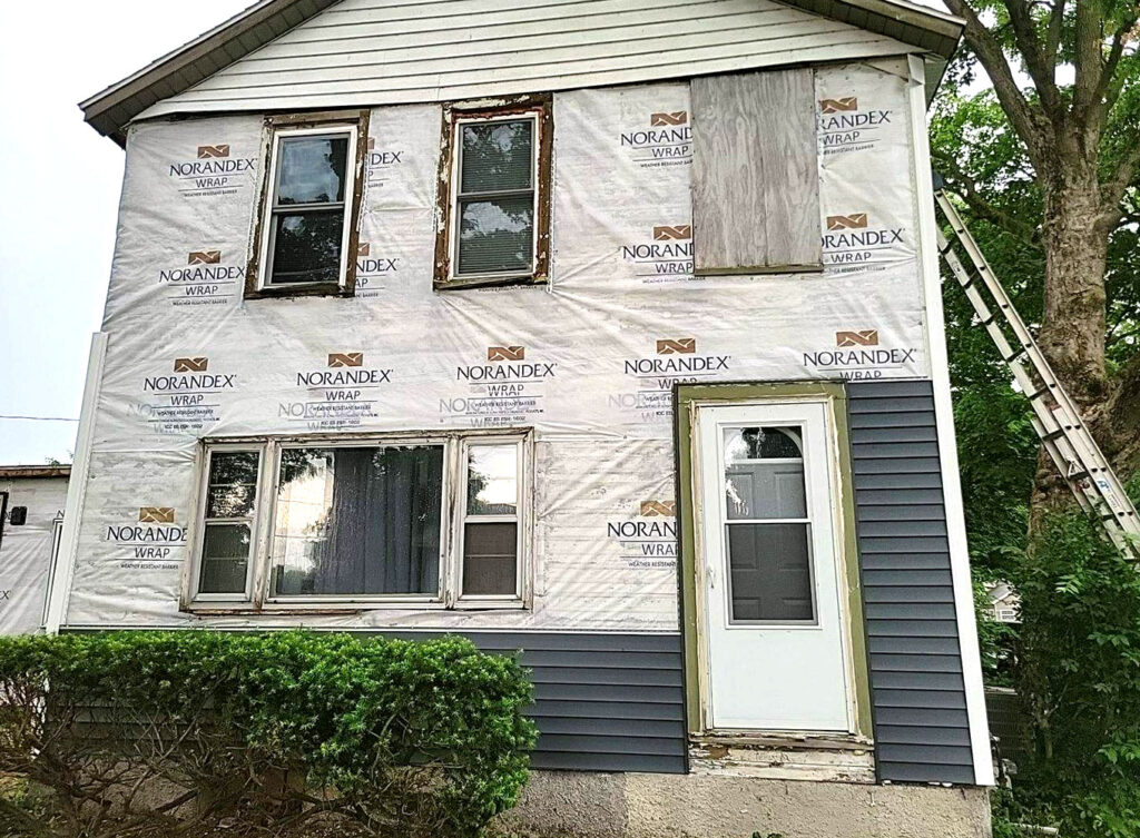 older home receiving siding replacement services by contractors in the granger indiana area