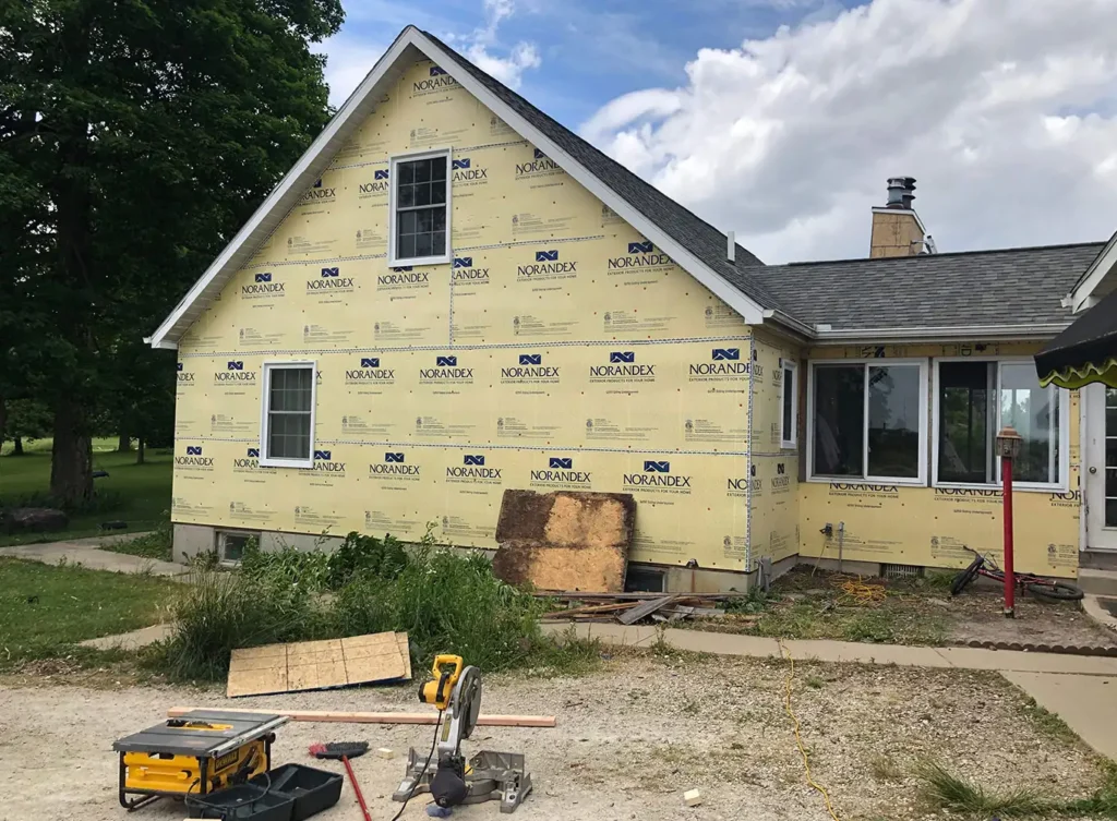 a home in bristol, in being renovated with new vinyl siding