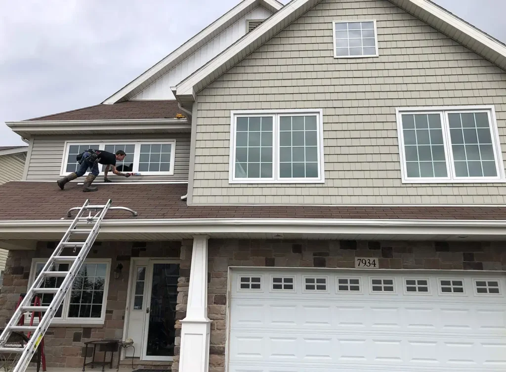 worker installing windows for a residential home in edwardsburg, mi
