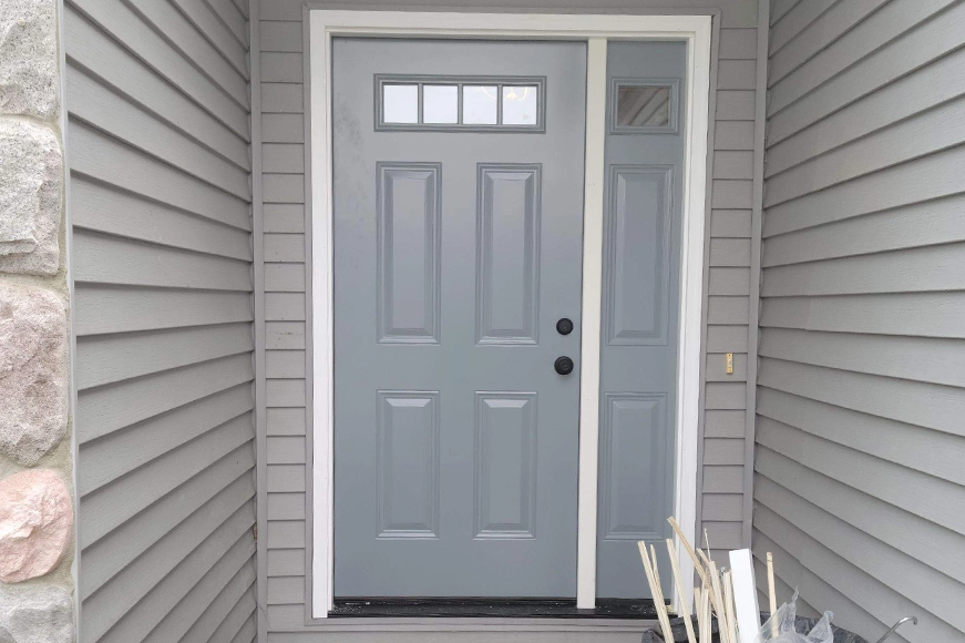 New grey entry door installed on the home of a Granger, IN resident.
