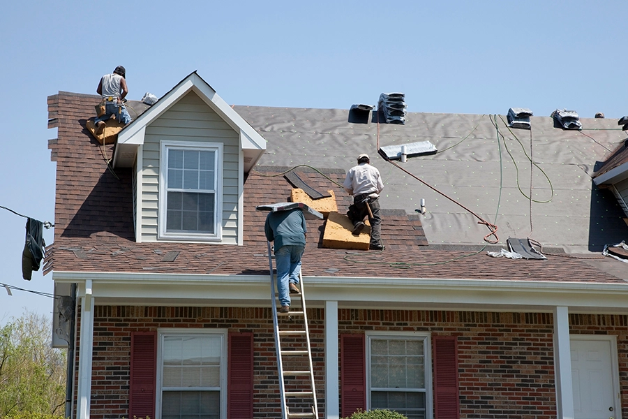 Professional roofers installing new shingles on a roof in Granger, IN.